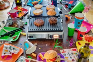 Grill with burger in a party setting