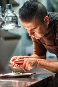 Michelin Star Chef Radek Kasparek preparing beetroot in the kitchen of his restaurant Field