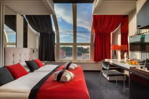 View on deluxe room with panorama windows showing a sunny afternoon sky at Hotel Clement Prague